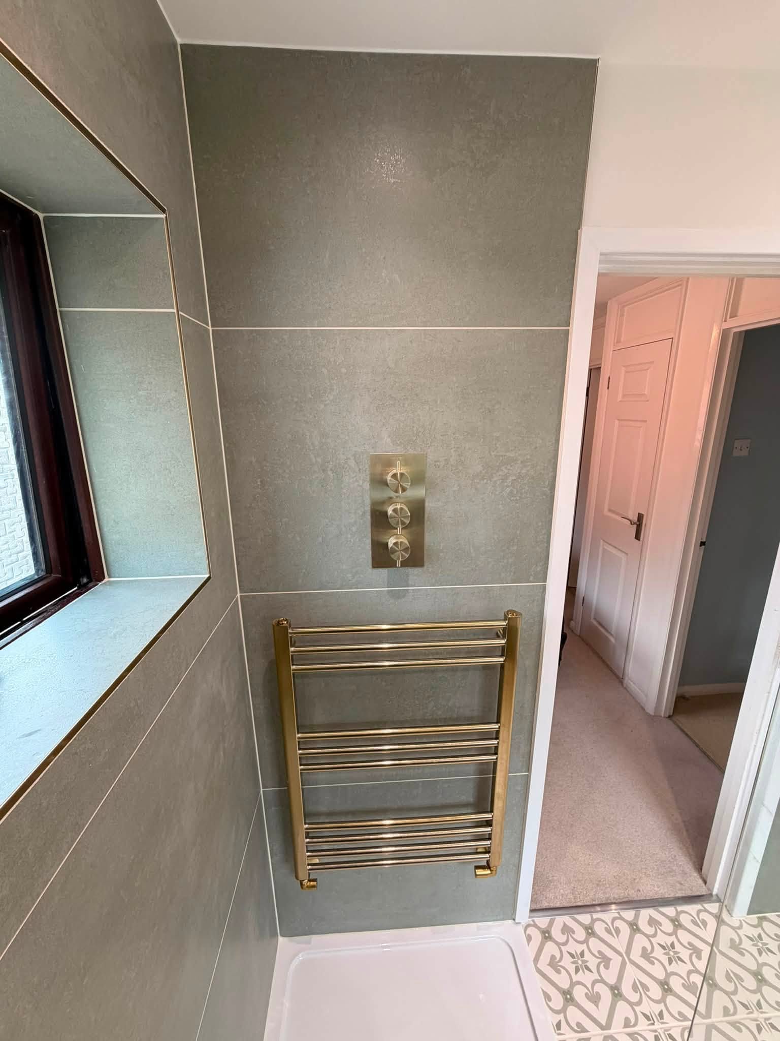 After: brushed brass thermostatic shower valve and towel rail